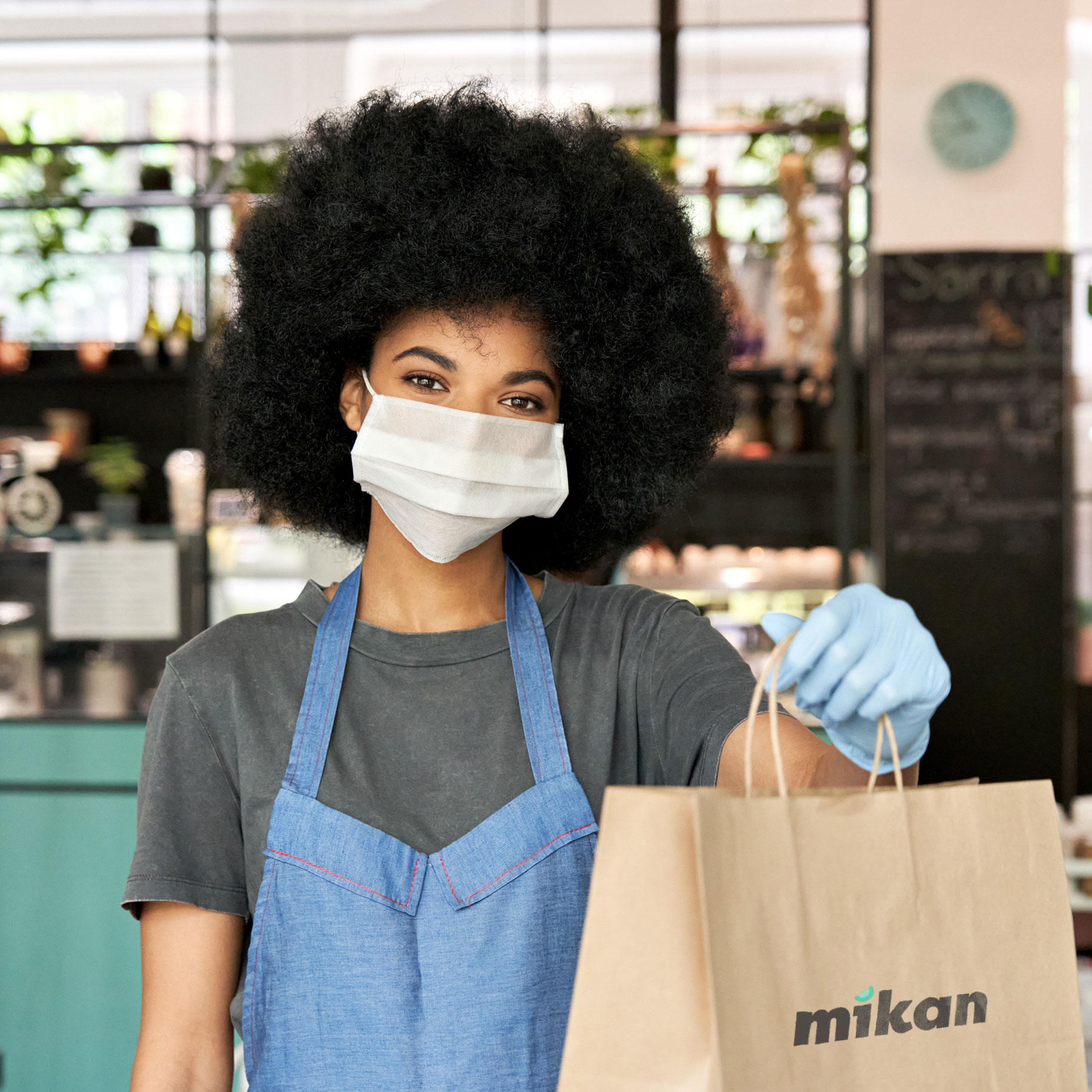 Restaurant waiter with bag for take-away